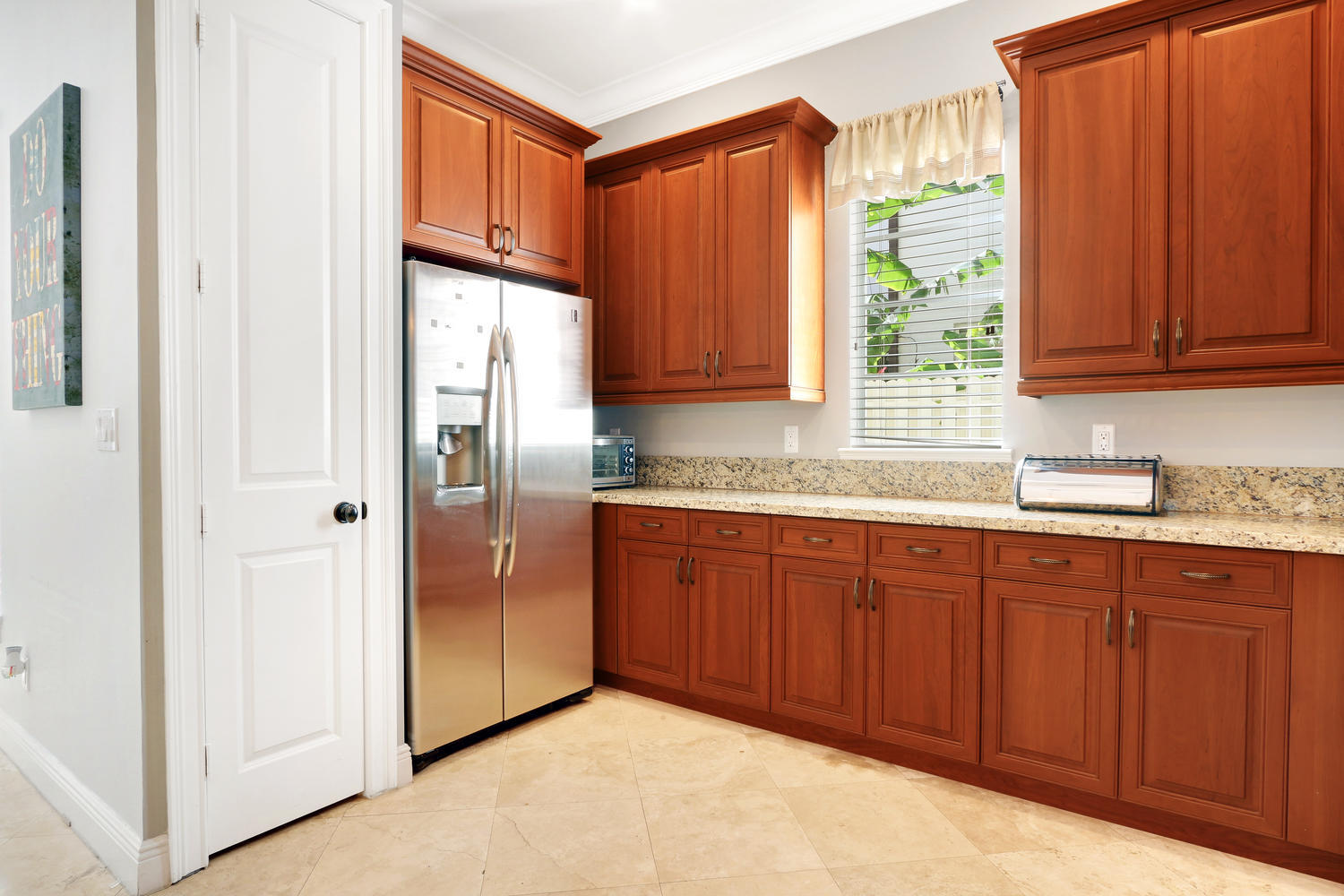 98 Via Poinciana Lane Boca Raton, FL 33487 - Photo 14 of 38 a kitchen with stainless steel appliances granite countertop a refrigerator and a sink
