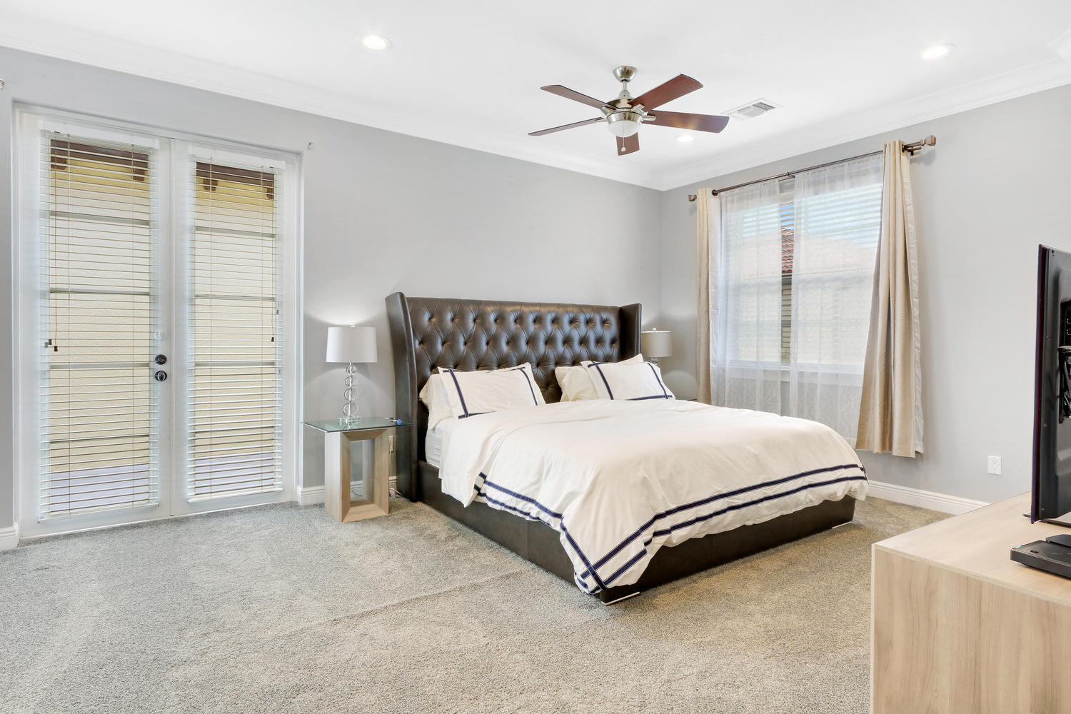 98 Via Poinciana Lane Boca Raton, FL 33487 - Photo 17 of 38 a bed sitting in a spacious bedroom next to a window