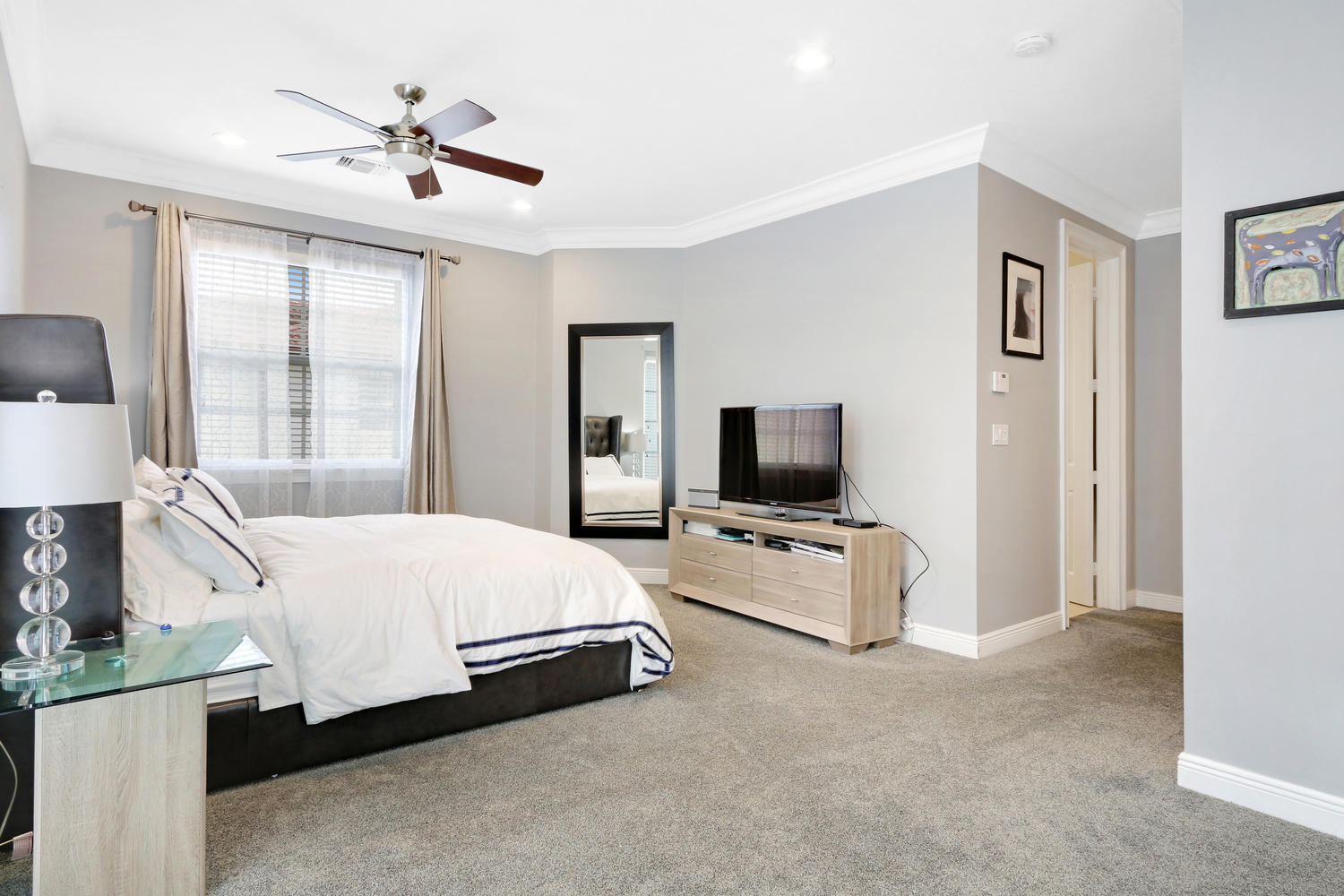 98 Via Poinciana Lane Boca Raton, FL 33487 - Photo 18 of 38 a bed room with a bed a television and a large window