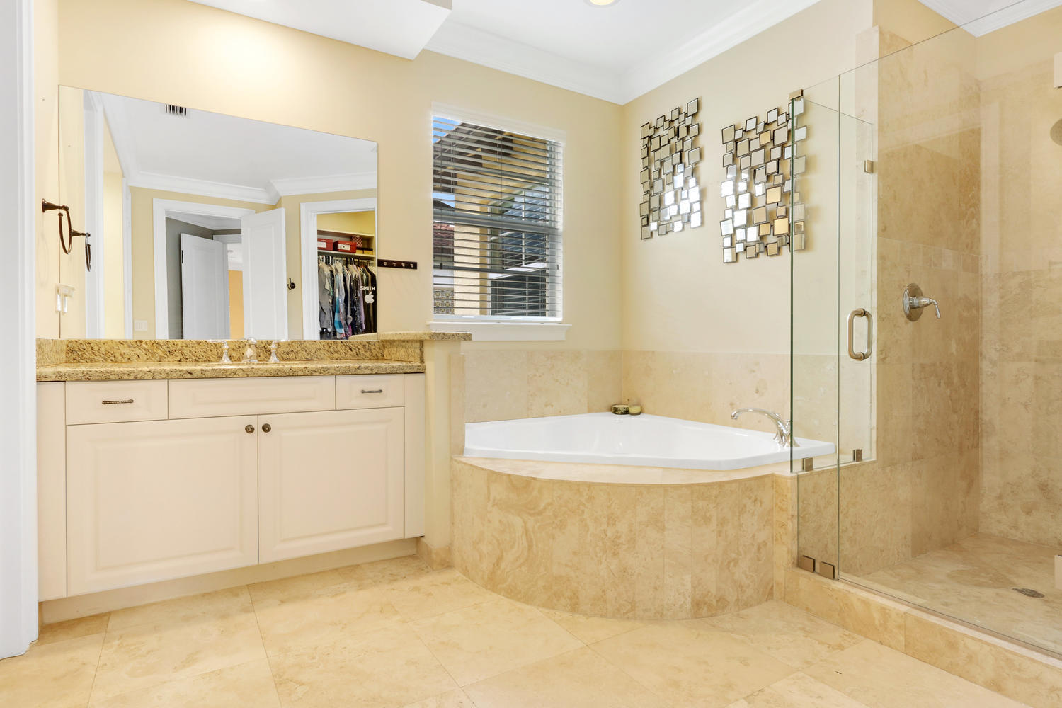 98 Via Poinciana Lane Boca Raton, FL 33487 - Photo 20 of 38 a spacious bathroom with a granite countertop sink a mirror and a bathtub