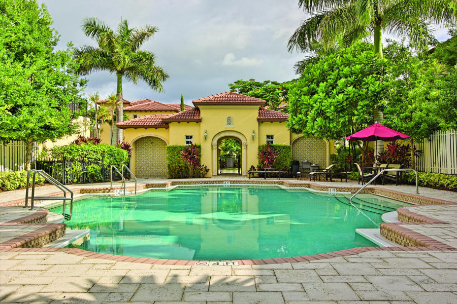 98 Via Poinciana Lane Boca Raton, FL 33487 - Photo 28 of 38 a house view with a swimming pool
