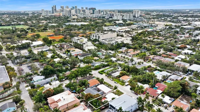 an aerial view of residential houses with city view