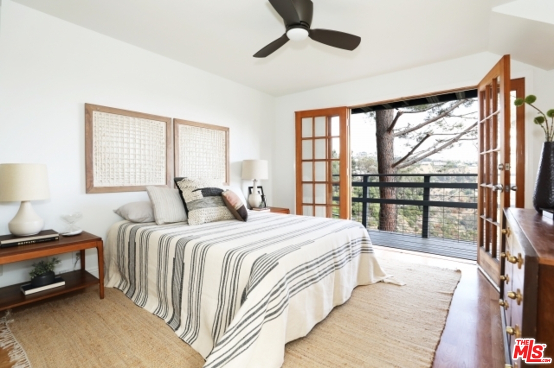 8400 Utica Drive Los Angeles, CA 90046 - Photo 18 of 32 a bedroom with a large bed and a large window