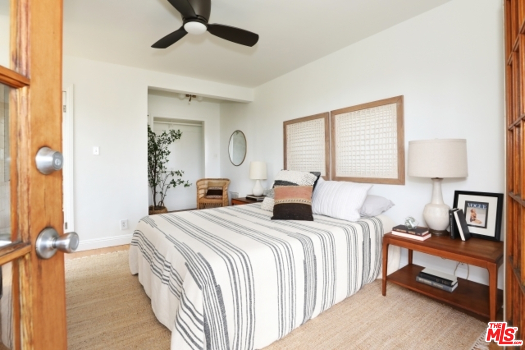 8400 Utica Drive Los Angeles, CA 90046 - Photo 20 of 32 a bedroom with a bed and a lamp on a dresser next to a window