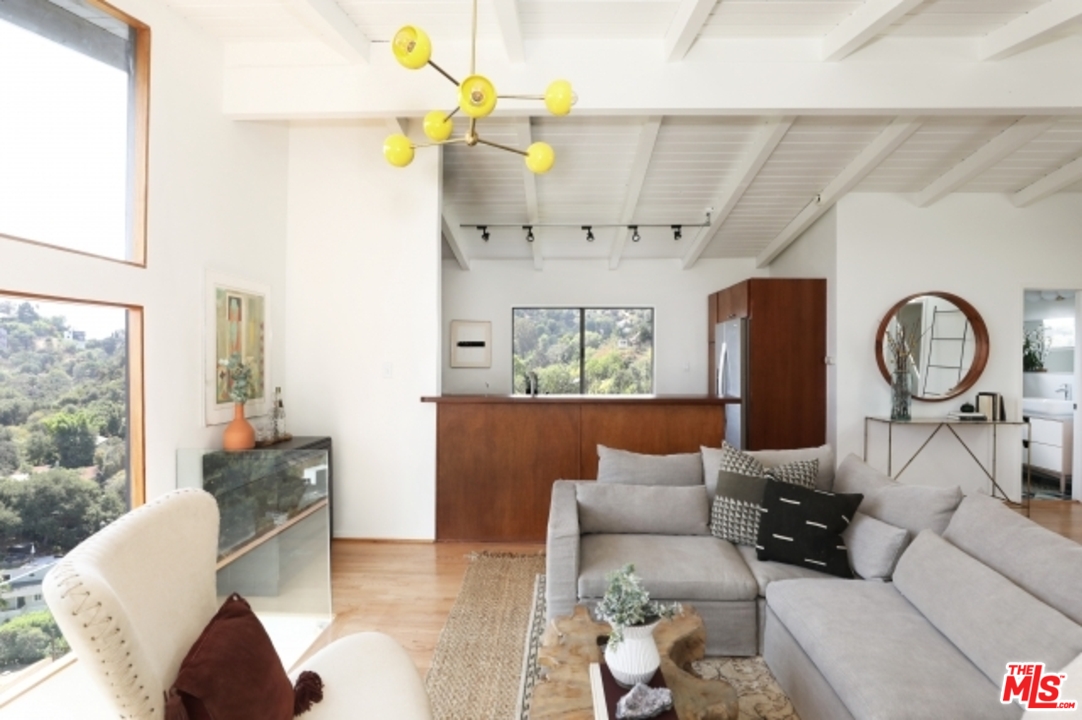 8400 Utica Drive Los Angeles, CA 90046 - Photo 6 of 32 a living room with furniture a fireplace and a chandelier