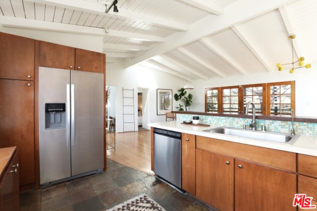 8400 Utica Drive Los Angeles, CA 90046 - Photo 8 of 32 a kitchen with a sink and refrigerator