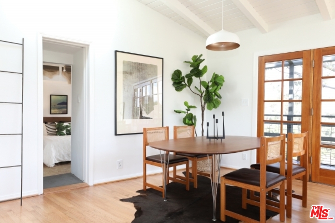 8400 Utica Drive Los Angeles, CA 90046 - Photo 9 of 32 a view of a dining room with furniture and a potted plant