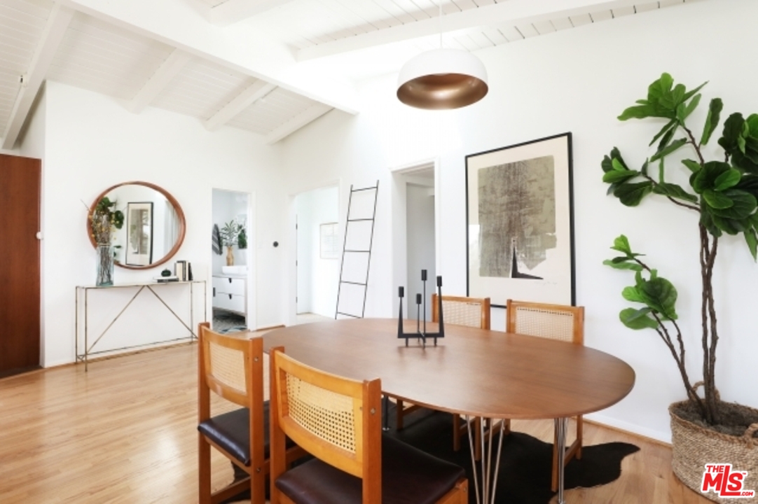 8400 Utica Drive Los Angeles, CA 90046 - Photo 10 of 32 a view of a dining room with furniture and a potted plant
