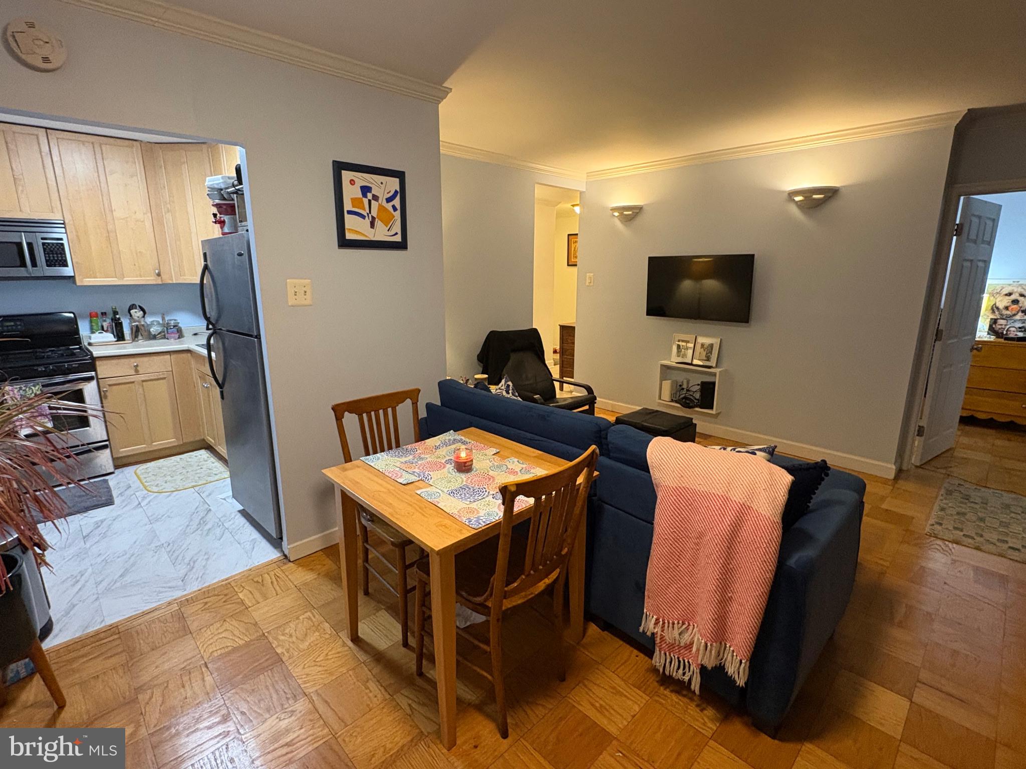 490 M Street Southwest, Unit W608 Washington, DC 20024 - Photo 5 of 12 a living room with furniture and a flat screen tv