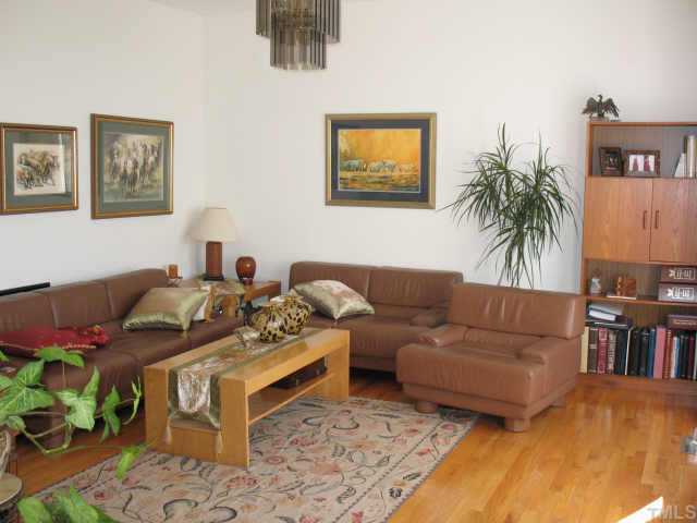 1809 Sarazen Place Raleigh, NC 27615 - Photo 2 of 9 a living room with furniture and a potted plant