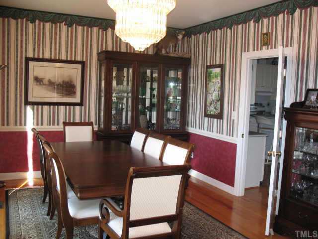 1809 Sarazen Place Raleigh, NC 27615 - Photo 3 of 9 a view of a dining room with furniture window and wooden floor