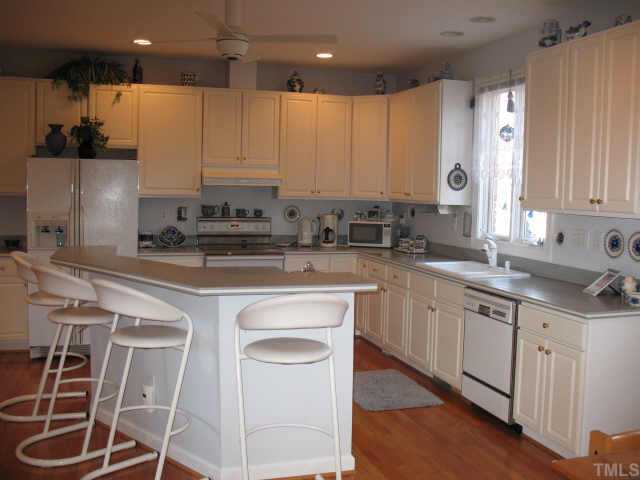1809 Sarazen Place Raleigh, NC 27615 - Photo 5 of 9 a kitchen with a sink cabinets and window