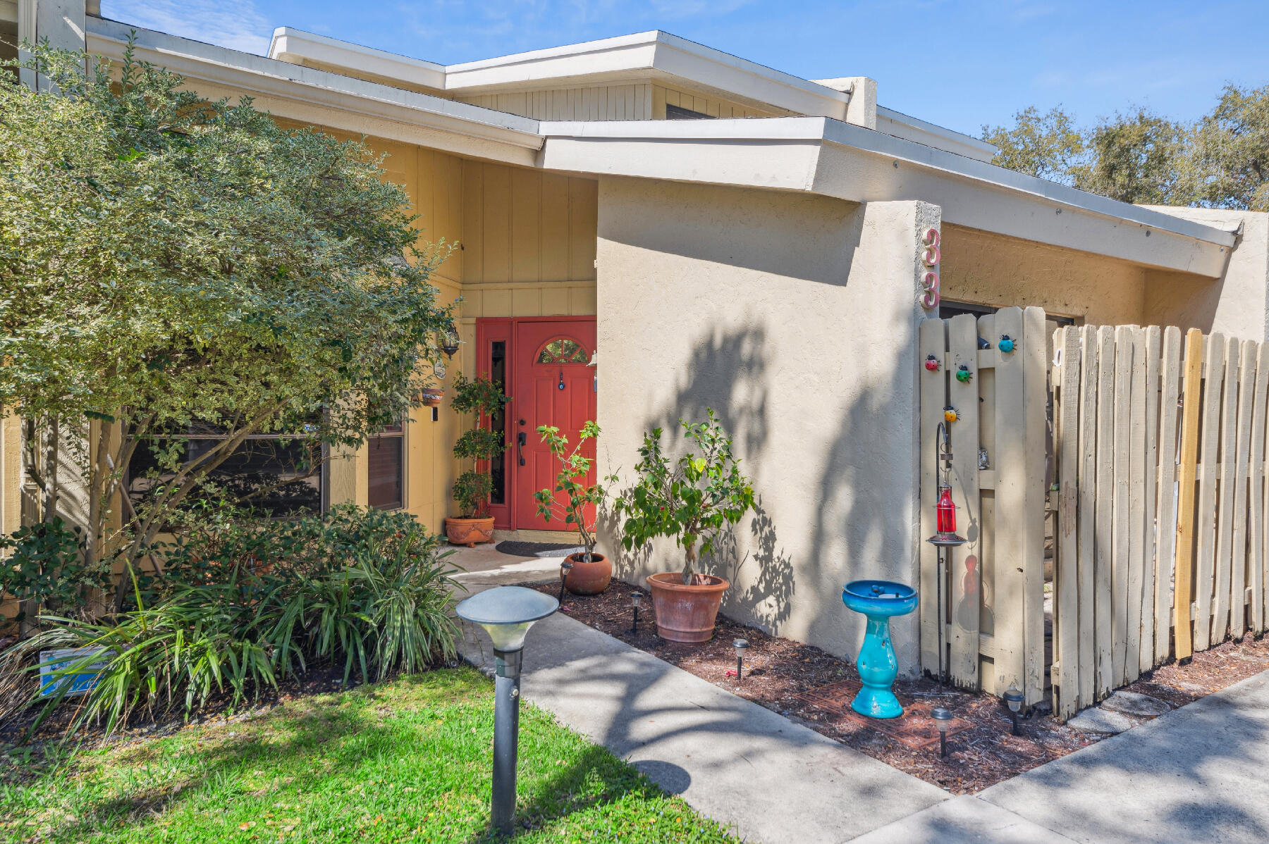 a front view of a house with plants