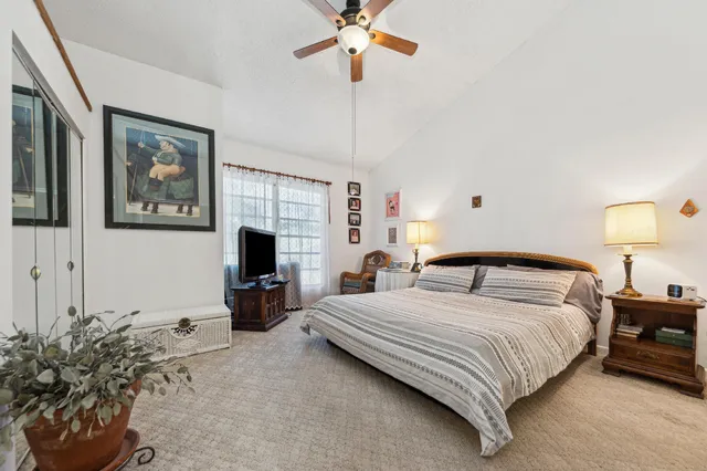a bedroom with a bed and a chandelier