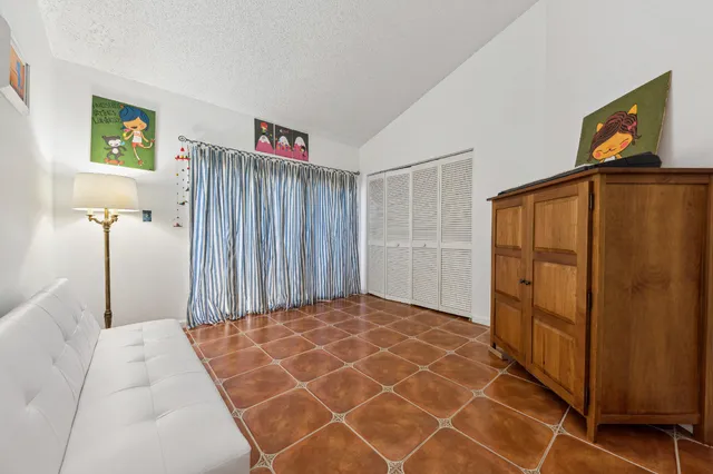 a bedroom with a bed and a painting on the wall