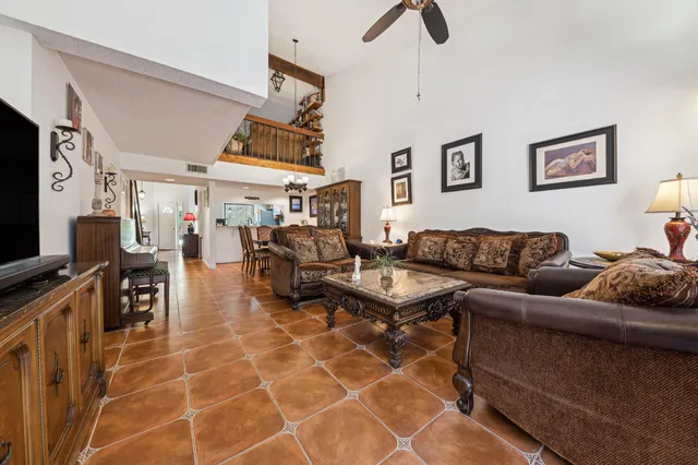 a living room with furniture a air conditioner and a window