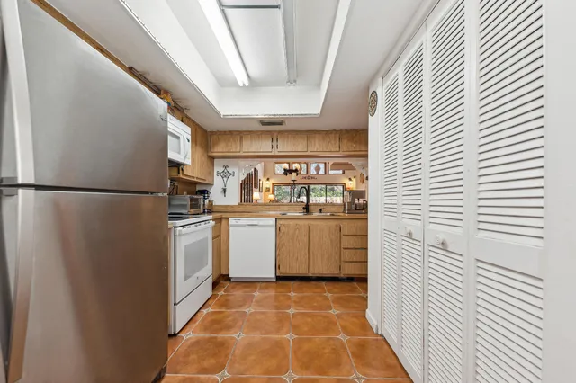 a kitchen with refrigerator and cabinets