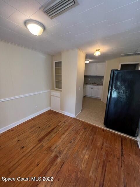 10 Olive Street Cocoa, FL 32922 - Photo 3 of 14 a view of empty room with wooden floor