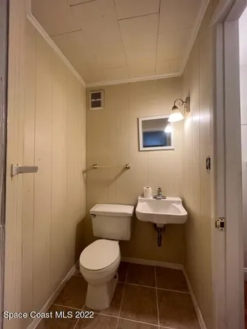 a bathroom with a toilet a sink and a mirror