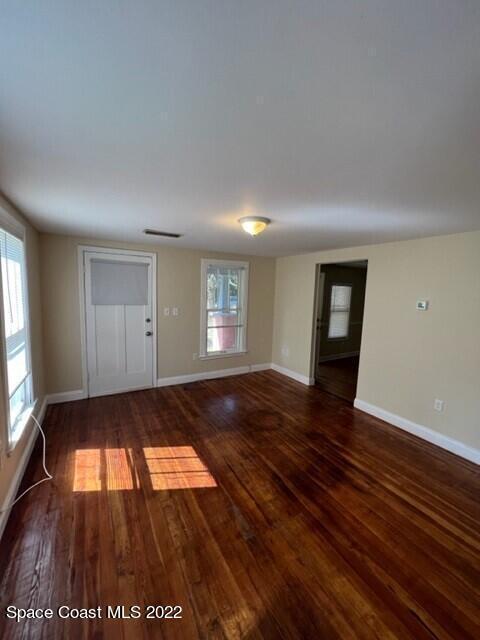 10 Olive Street Cocoa, FL 32922 - Photo 7 of 14 wooden floor in an empty room with window