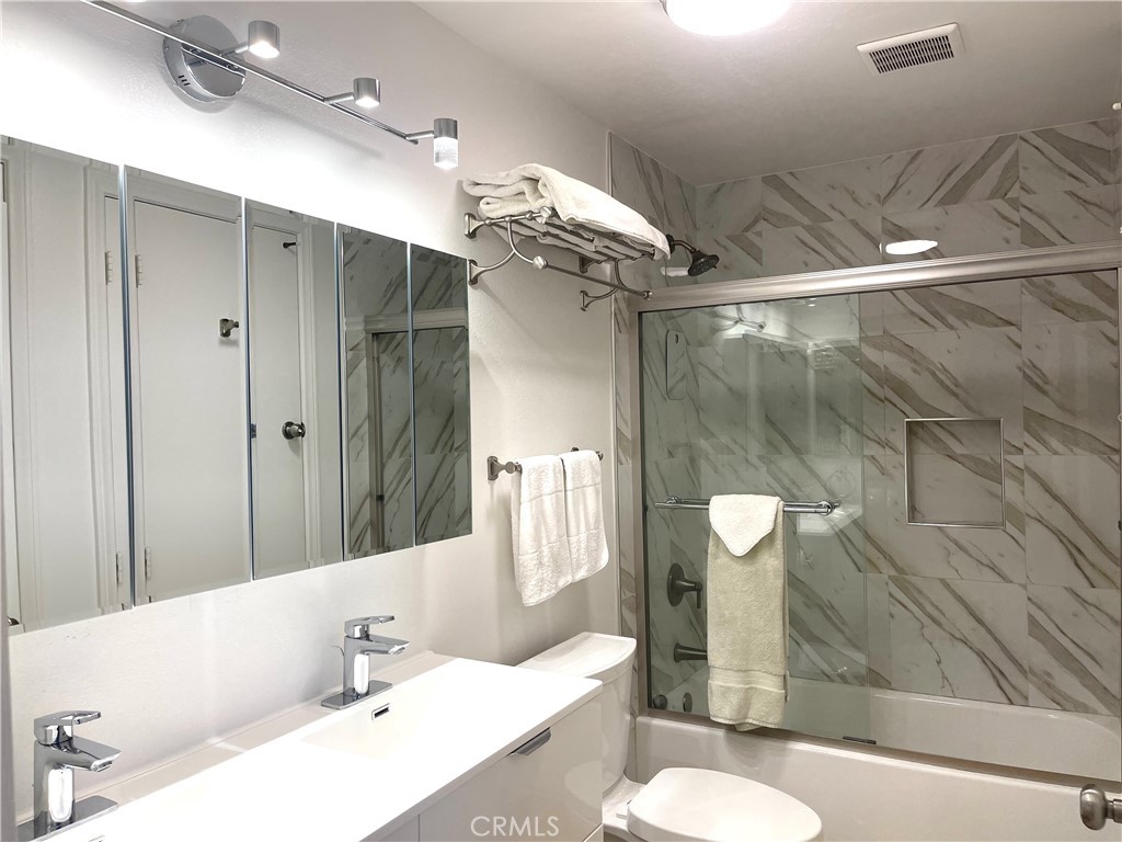 352 Y Place Laguna Beach, CA 92651 - Photo 11 of 22 a bathroom with a sink and mirror with bathtub