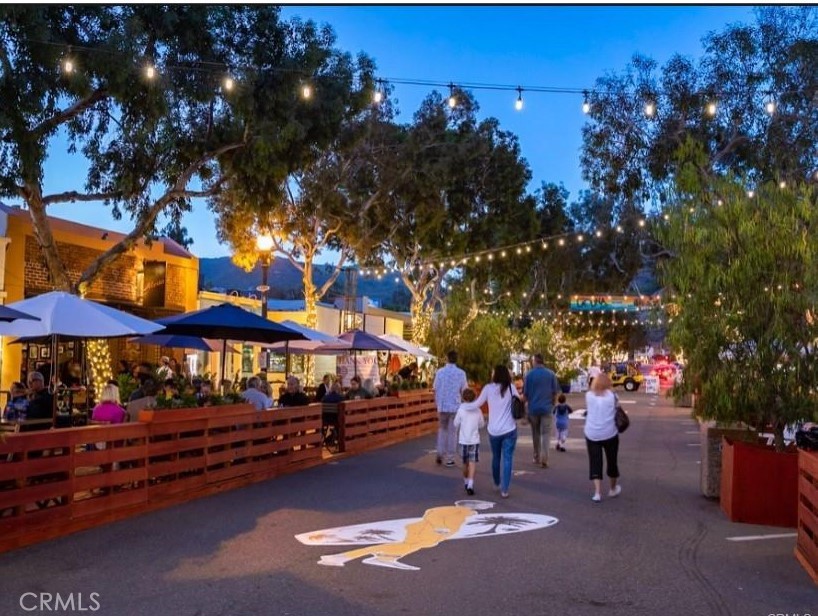 352 Y Place Laguna Beach, CA 92651 - Photo 21 of 22 a group of people sitting in a yard in front of retail shops