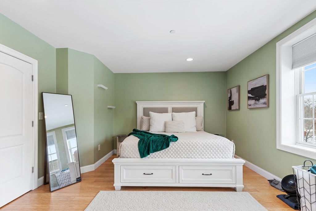 30 High Street, Unit 31 Medford, MA 02155 - Photo 19 of 27 a bedroom with a bed and a dresser