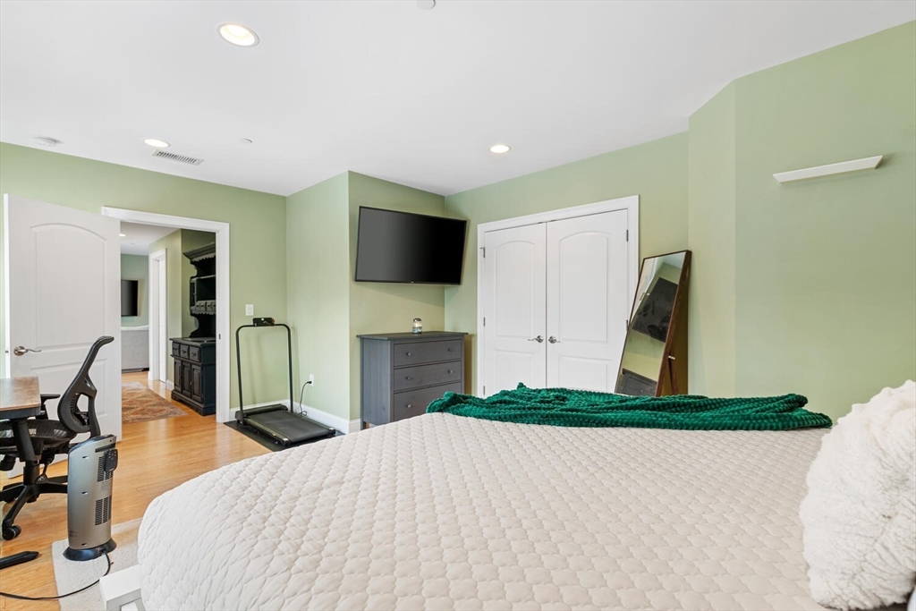 30 High Street, Unit 31 Medford, MA 02155 - Photo 21 of 27 a bedroom with a bed and a flat screen tv