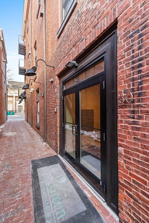 30 High Street, Unit 31 Medford, MA 02155 - Photo 4 of 27 a view of a brick house with a large door