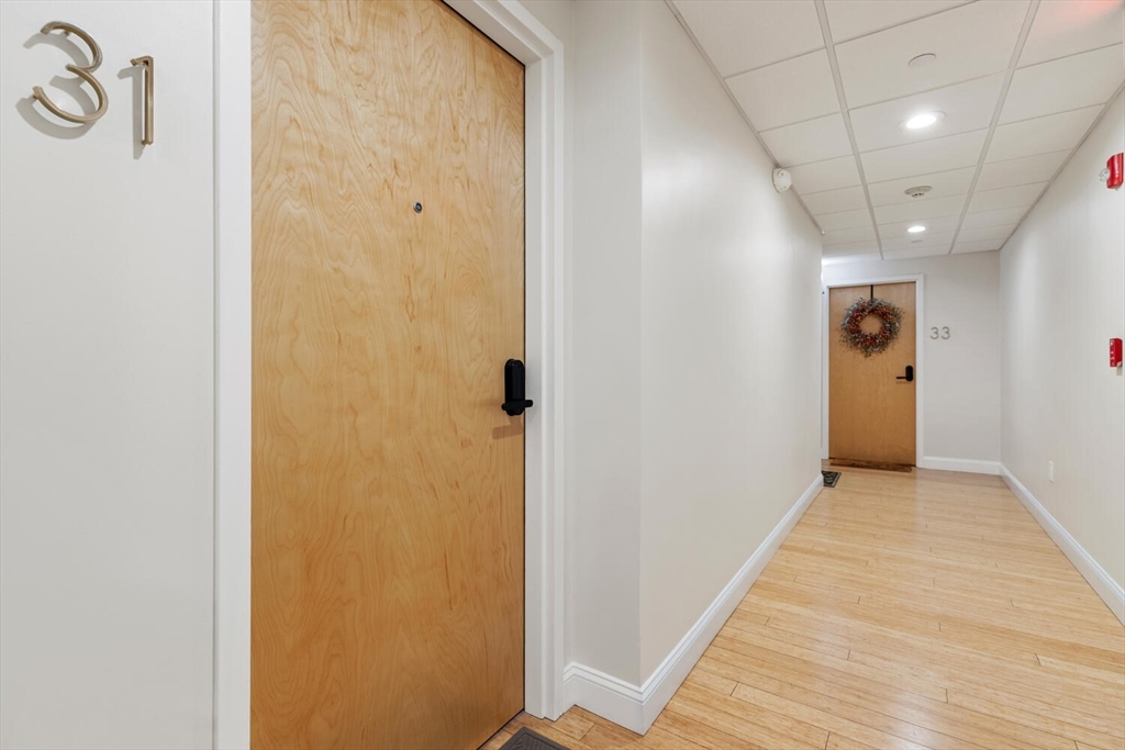 30 High Street, Unit 31 Medford, MA 02155 - Photo 5 of 27 a view of a hallway with wooden floor