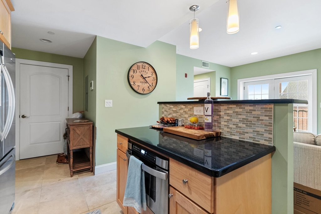 30 High Street, Unit 31 Medford, MA 02155 - Photo 8 of 27 a kitchen with a cabinets and chandelier