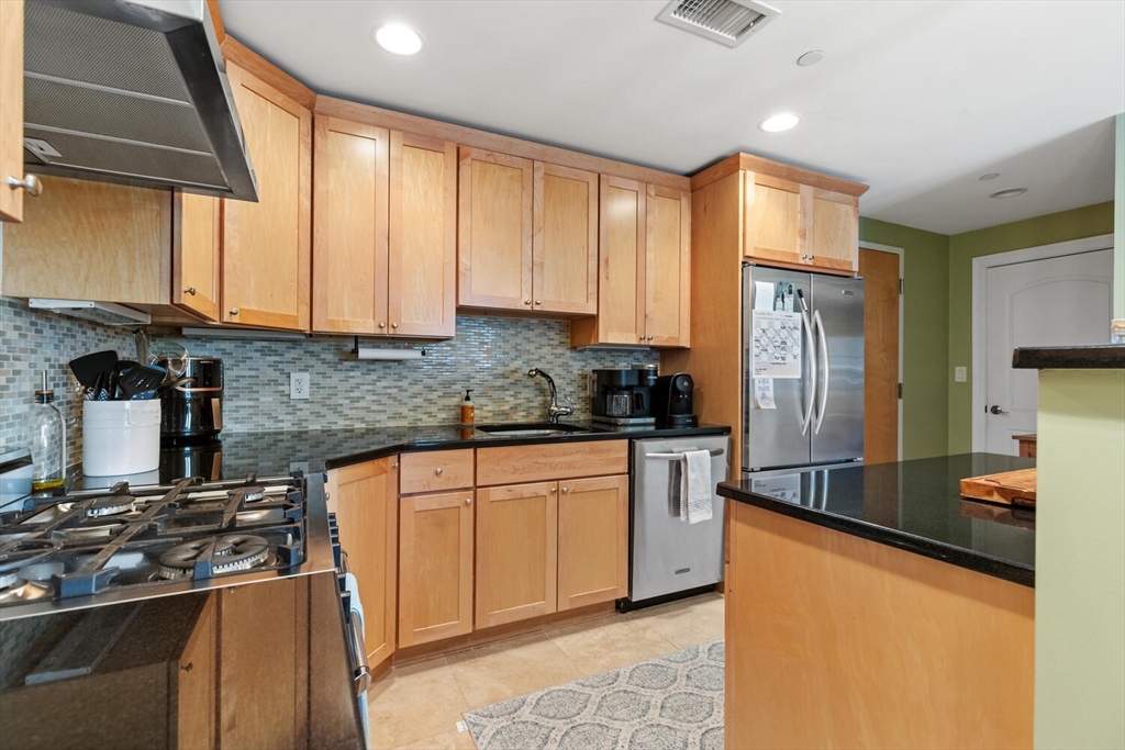 30 High Street, Unit 31 Medford, MA 02155 - Photo 9 of 27 a kitchen with stainless steel appliances granite countertop a stove a refrigerator and a sink