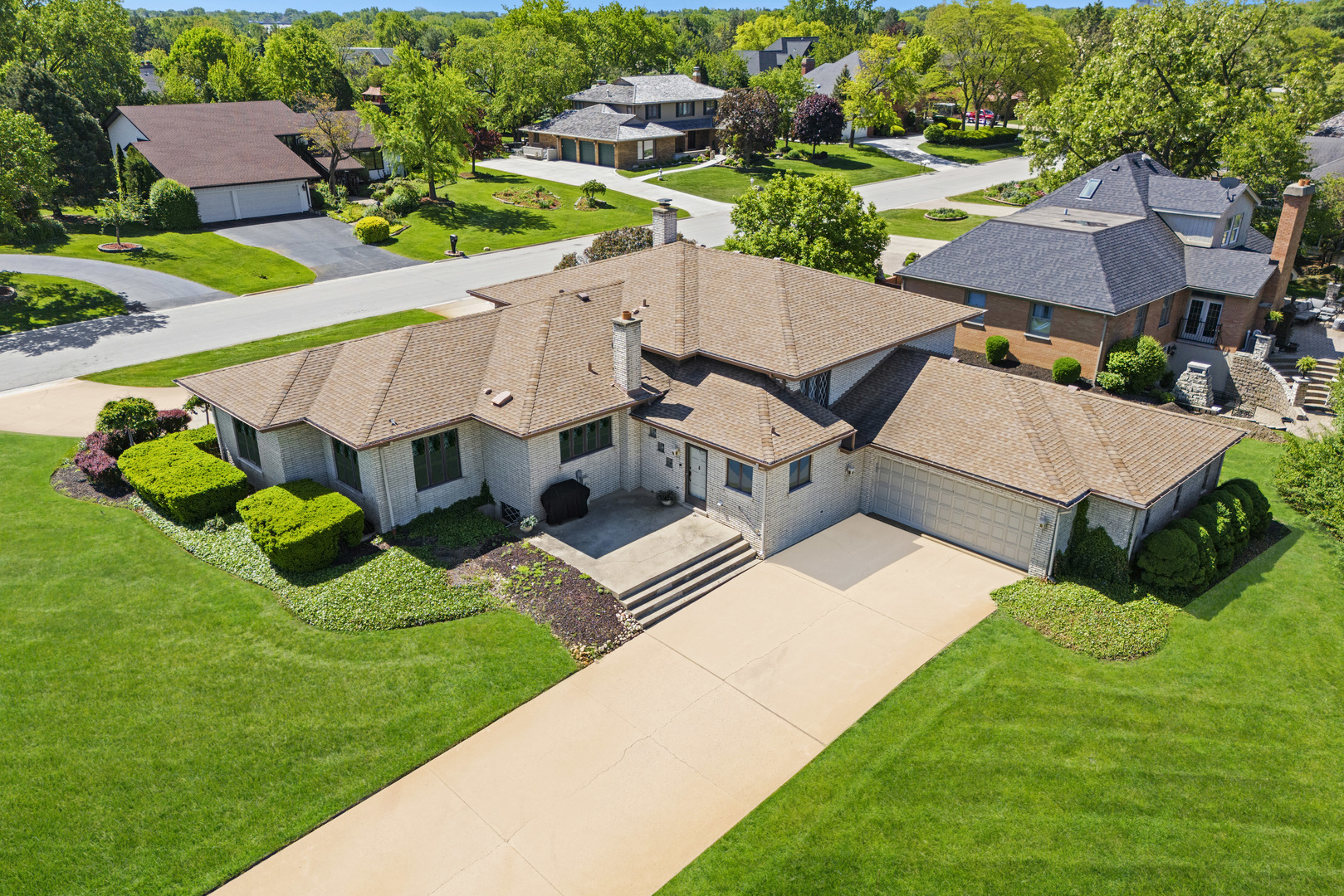 an aerial view of a house with garden space and street view
