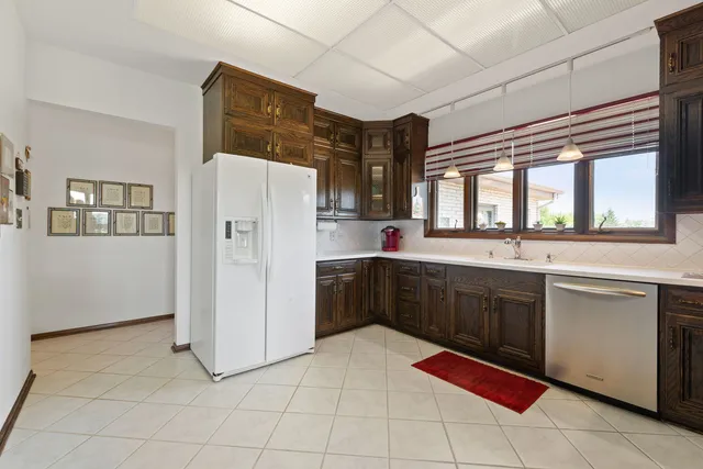 a kitchen with stainless steel appliances a refrigerator sink and cabinets