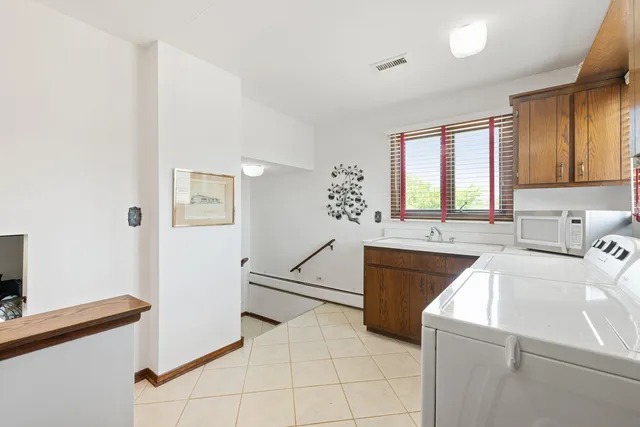 a kitchen that has a sink and a stove in it