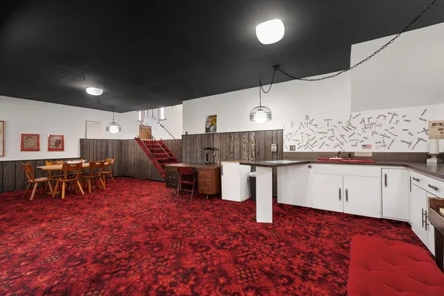 a living room with a table and chairs