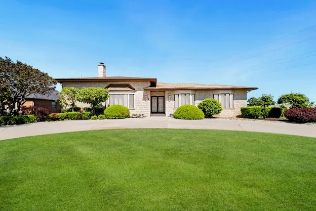 a front view of a house with a garden