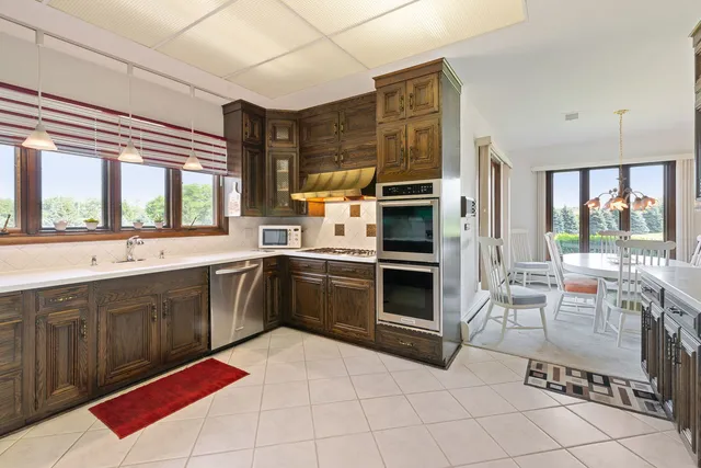 a kitchen with stainless steel appliances a stove sink and cabinets