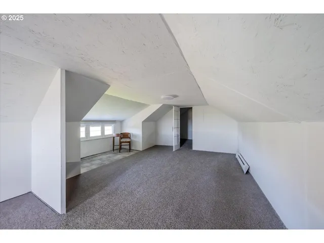 a view of empty room with a fireplace