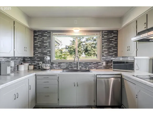 a kitchen with a sink and large window