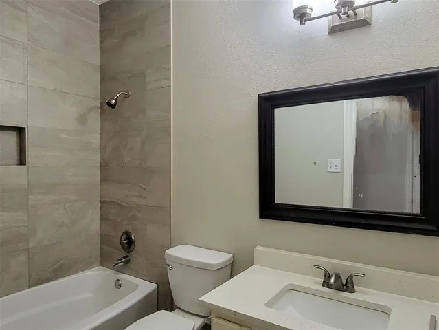 a bathroom with a toilet a sink and a mirror