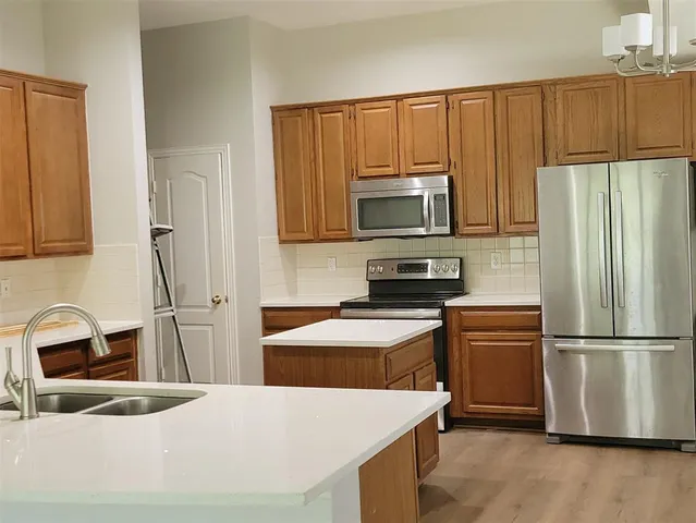 a kitchen with a refrigerator sink and microwave