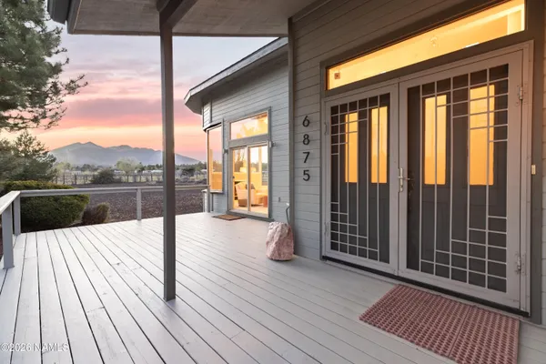 a view of balcony with wooden floor and fence