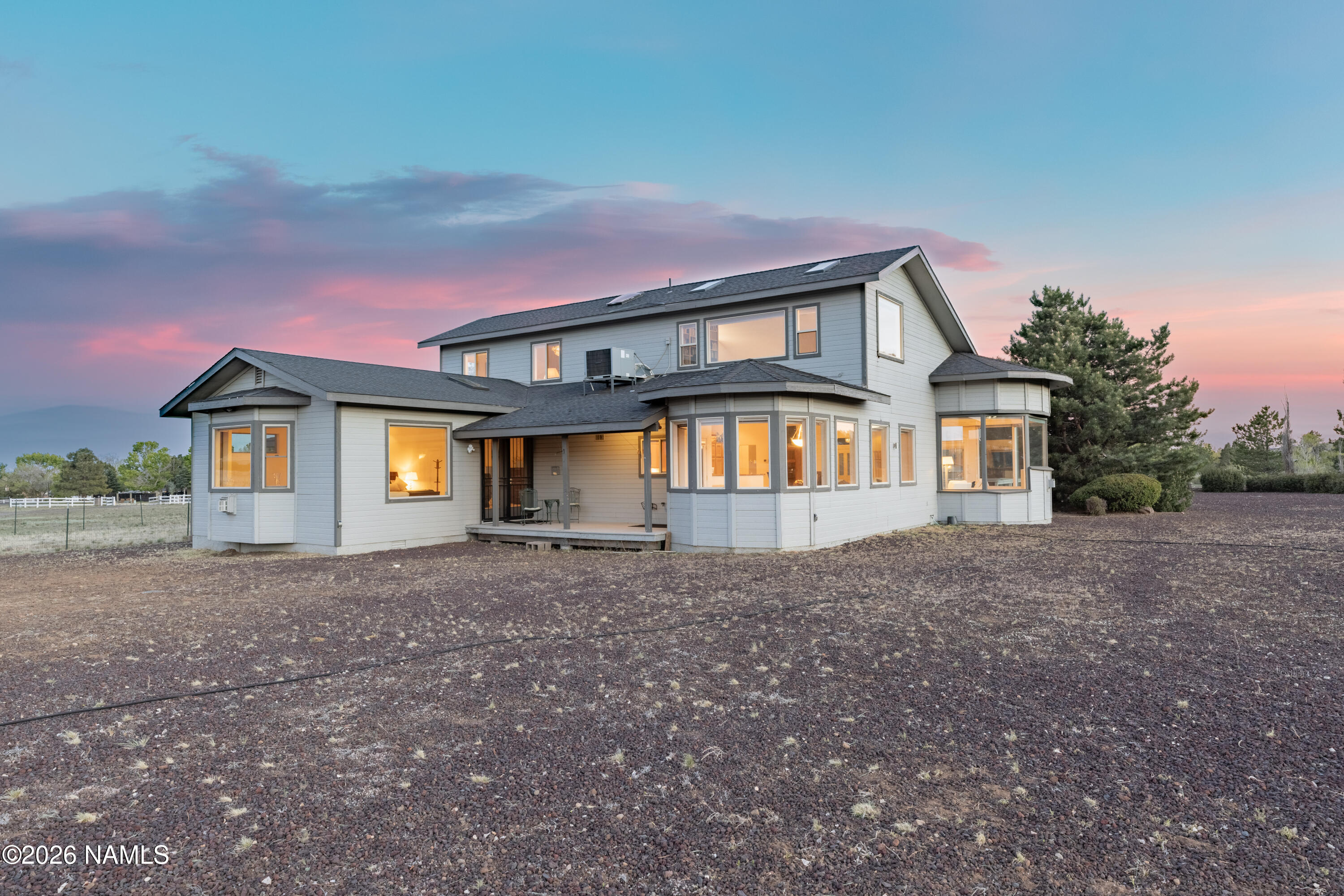 6875 Will O' Pete Road Flagstaff, AZ 86004 - Photo 20 of 43 a front view of a house with a yard and garage