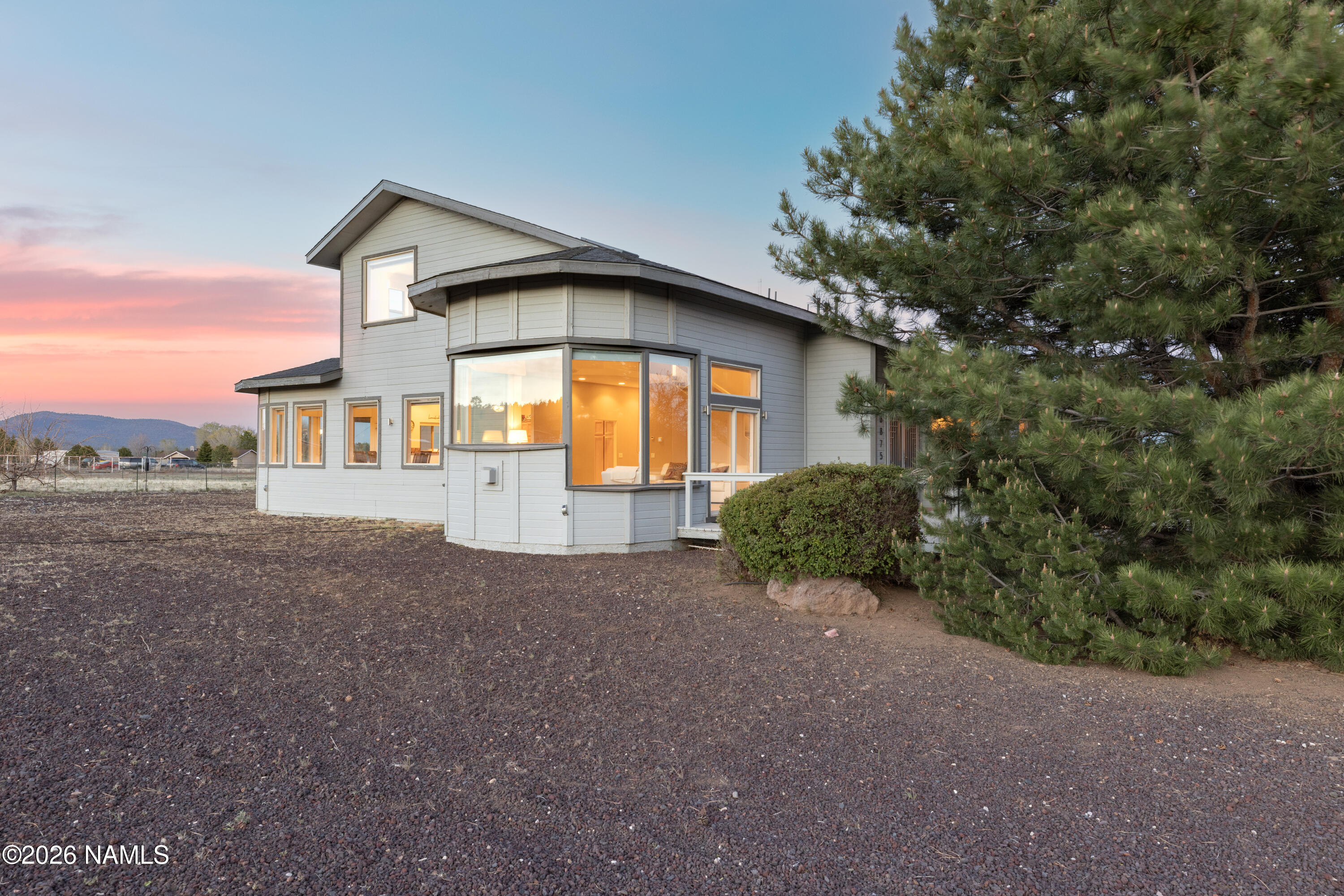 6875 Will O' Pete Road Flagstaff, AZ 86004 - Photo 21 of 43 a front view of a house with a yard