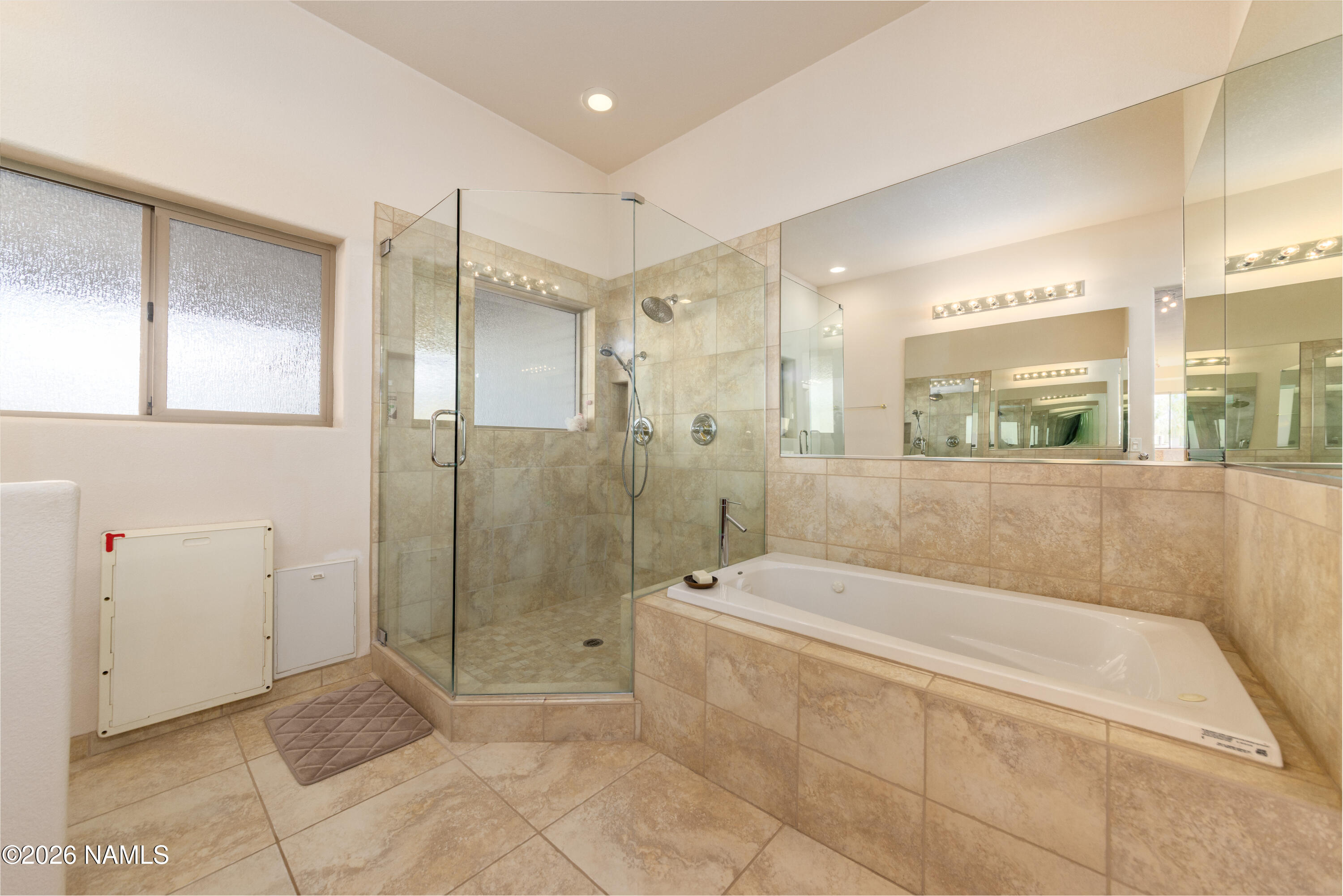 6875 Will O' Pete Road Flagstaff, AZ 86004 - Photo 27 of 43 a spacious bathroom with a granite countertop shower a sink and a mirror