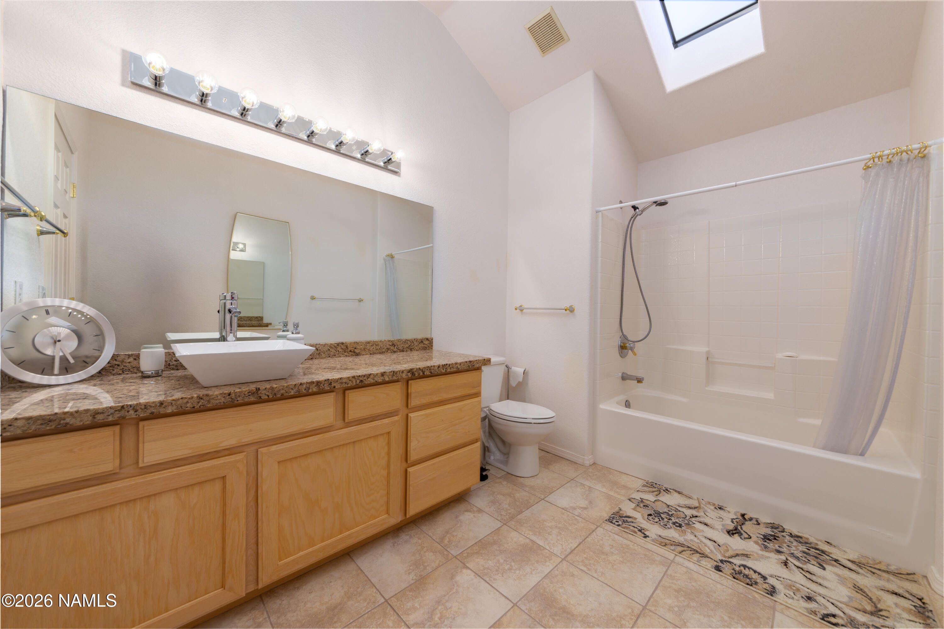 6875 Will O' Pete Road Flagstaff, AZ 86004 - Photo 36 of 43 a bathroom with a granite countertop sink a toilet and a bathtub