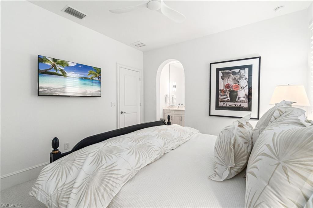 16755 Lucarno Way Naples, FL 34110 - Photo 19 of 50 a bedroom with a bed and a painting on the wall