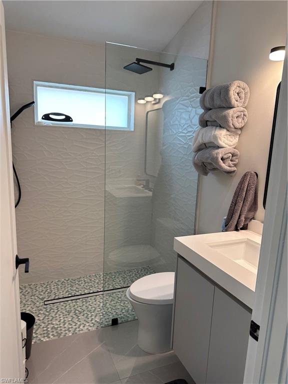 1595 Whispering Oaks Circle Naples, FL 34110 - Photo 12 of 15 a bathroom with a toilet and a shower