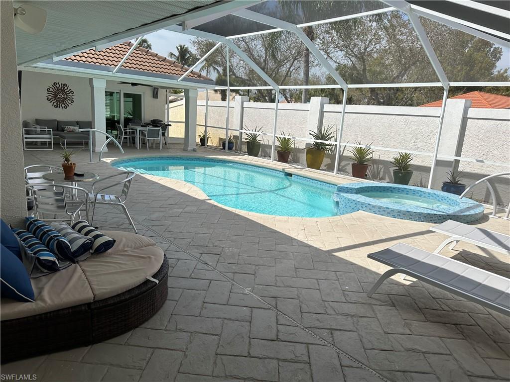 1595 Whispering Oaks Circle Naples, FL 34110 - Photo 15 of 15 a view of a swimming pool with sitting area